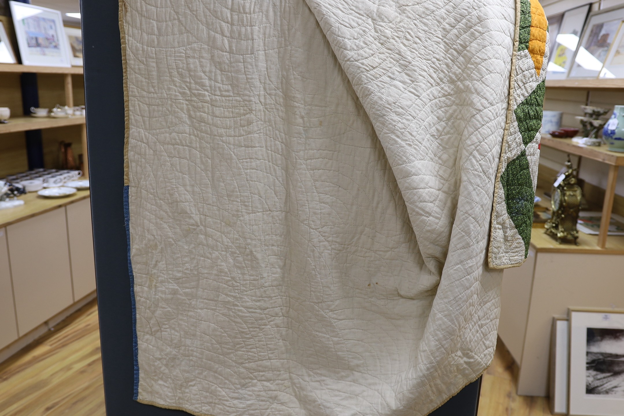 An American style multi coloured patchwork quilted cover, -170 cms long x 168 wide.